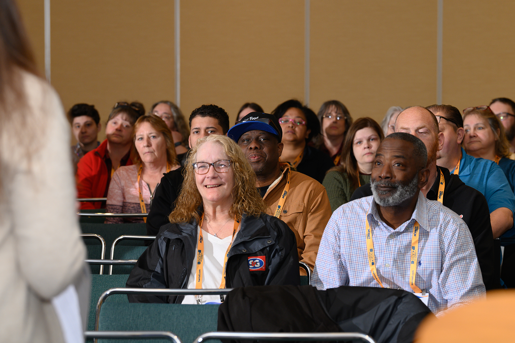 Man and Woman sitting front row during an education session at M-PACT